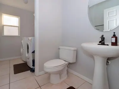 a bathroom with a toilet and a sink and a mirror at Holiday Home Villa mit 6 Schlafzimmern und atemberaubendem Seeblick by Interhome in Kissimmee