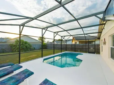 a swimming pool with a glass roof over a backyard at Holiday Home Ausgezeichnetes Preis-Leistungs-Verhältnis Familienvilla - Süd-West Privater Po by Interhome in Kissimmee