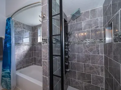 a bathroom with a shower and a bath tub at Holiday Home Moderne Villa mit Seeblick nur wenige Minuten von Disney entfernt by Interhome in Kissimmee