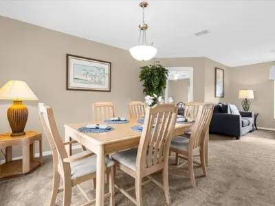 a dining room with a table and chairs at Holiday Home 3-Schlafzimmer Value Plus Haus mit privatem Pool by Interhome in Kissimmee