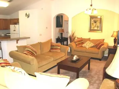 a living room with two couches and a table at Holiday Home 3-Schlafzimmer Value Plus Haus mit privatem Pool by Interhome in Kissimmee