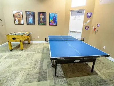 a room with a ping pong table in it at Holiday Home Florida Breeze mit Whirlpool by Interhome in Kissimmee