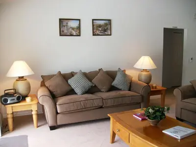 a living room with a brown couch and two lamps at Holiday Home Villa Glenbrook Resort by Interhome in Orlando