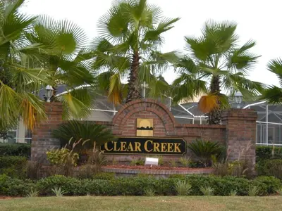 a sign in front of a building with palm trees at Holiday Home Familienfreundliche Villa nahe der Disney-Parks by Interhome in Orlando