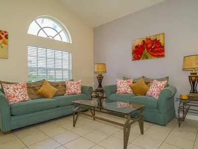 a living room with two couches and a table at Holiday Home Ruhige Glenbrook-Flucht in der Nähe von Disney by Interhome in Orlando