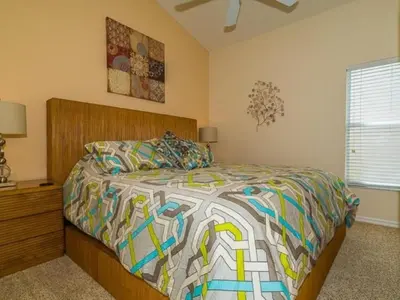 a bedroom with a bed with a colorful comforter at Holiday Home Ruhige Glenbrook-Flucht in der Nähe von Disney by Interhome in Orlando