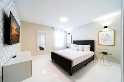 a bedroom with a bed and a table in it at Storey Lake Resort 9Q c/ Piscina & Game Room in Kissimmee