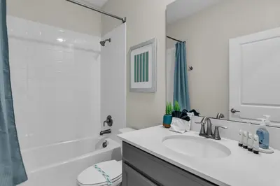 a white bathroom with a sink and a shower at Disney & Universal House with Pool & Arcade in Kissimmee