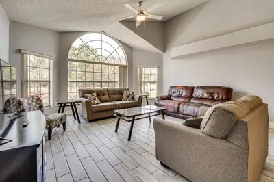 a living room with couches and a table at Family Theme Park Hub with Pool in Kissimmee in Kissimmee
