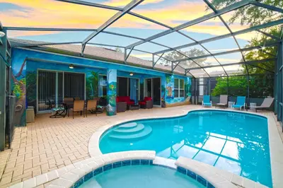 a swimming pool with a pergola next to a house at 4BR Family Villa Pool Game Room Near Disney in Orlando