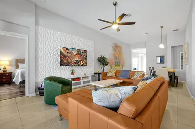 a living room with a couch and a table at 4BR Family Villa Pool Game Room Near Disney in Orlando