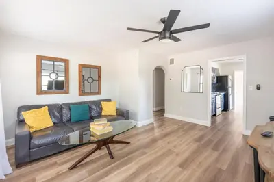 a living room with a couch and a ceiling fan at The Pineapple Express in Orlando