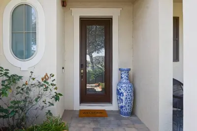 a blue and white vase sitting in front of a door at Comfort & Charm in Central Florida in Sanford