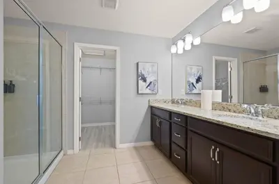 a bathroom with two sinks and a shower at Comfort & Charm in Central Florida in Sanford