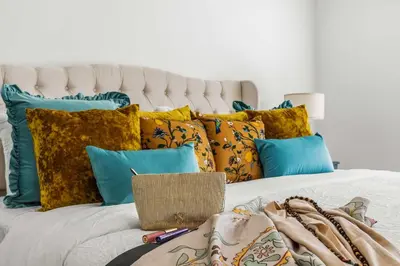 a white bed with a bunch of pillows on it at Residentas Hali Ridge in Orlando