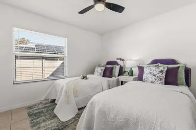 a bedroom with two beds and a window at Residentas Hali Ridge in Orlando