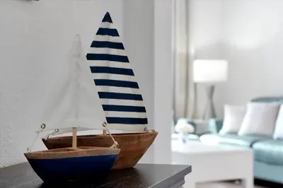 a wooden toy boat sitting on a table in a living room at Universal Studios EPIC Splash Park 2BR CONDO ADA in Orlando
