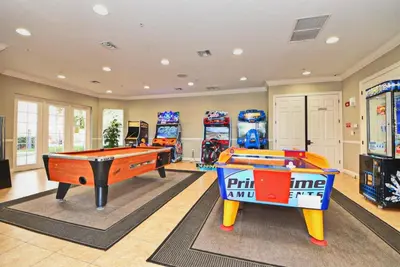 a room with two pool tables and arcade games at Universal Studios EPIC Splash Park 2BR CONDO ADA in Orlando