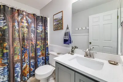a bathroom with a toilet and a shower curtain at Visit Disney and Universal Parks! Group-Friendly Gem in Orlando