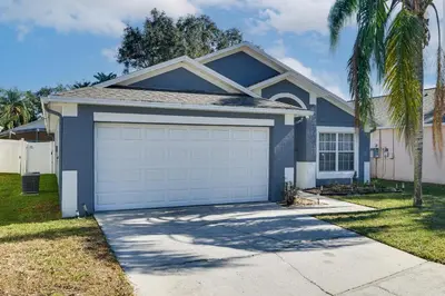 a blue house with a garage at Visit Disney and Universal Parks! Group-Friendly Gem in Orlando