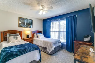 a blue bedroom with two beds and a window at Visit Disney and Universal Parks! Group-Friendly Gem in Orlando