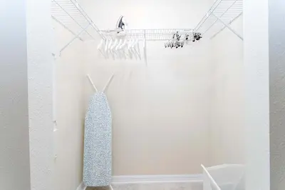 a white room with a tie hanging on a wall at Lake view Near Disney Resort w Lazy River 108 in Kissimmee