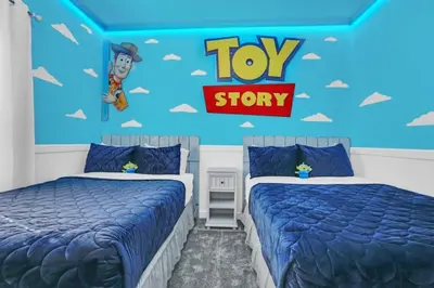 two beds in a room with a toy story bedroom at Luxury, Luxury, Luxury Pool Home! townhouse in Kissimmee