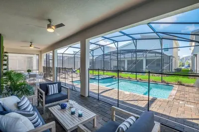a view of a patio with a swimming pool at 9 Bedroom With Everything For Happiness! home in Kissimmee