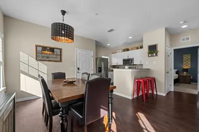 a dining room and kitchen with a table and chairs at Relaxing Resort Townhome Close to Disney in Kissimmee
