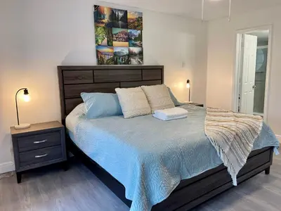 a bedroom with a bed with a blue comforter at Superior 3BR Condo Apartment Near Disney Attractions in Kissimmee