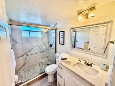 a bathroom with a shower and a toilet and a sink at Superior 3BR Condo Apartment Near Disney Attractions in Kissimmee