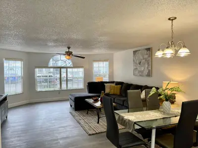 a living room with a couch and a table at Superior 3BR Condo Apartment Near Disney Attractions in Kissimmee