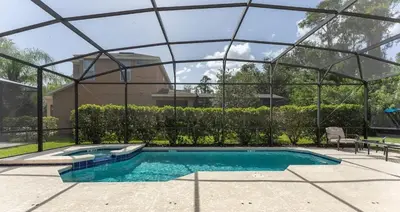 a swimming pool with a glass enclosure around it at Casa 6Q Bella Vida Resort – Perto Disney in Kissimmee