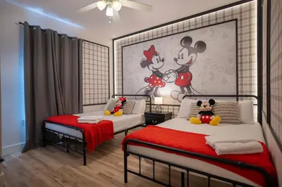 a bedroom with two beds and a mickey mouse mural at Family 3BR Home in Lucaya Resort in Kissimmee