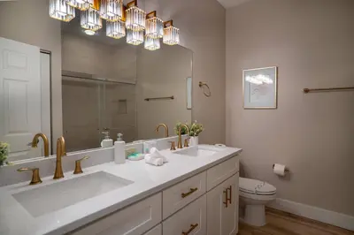 a bathroom with a large sink and a mirror at Family 3BR Home in Lucaya Resort in Kissimmee