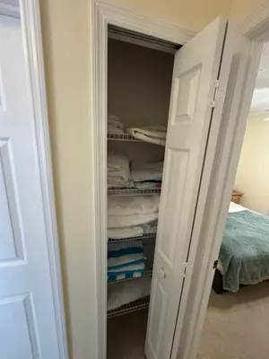 a closet with a white door and some towels at 4813 Pliny Court in Kissimmee