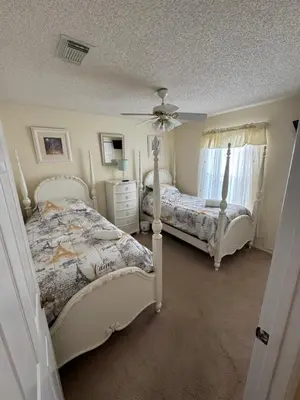 a bedroom with two beds and a ceiling fan at 4813 Pliny Court in Kissimmee
