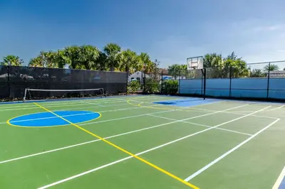 a tennis court with a net on top of it at Disney Min Away - Pool Patio & BBQ in Orlando