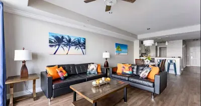 a living room with a black couch and a table at Blue Heron Resort in Orlando