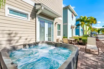 a hot tub in the backyard of a house at Tropical Cottage With Hot Tub Near Disney With Margaritaville Resort And Island H20 Waterpark Access - 8040Dr in Orlando