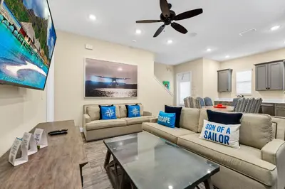 a living room with couches and a ceiling fan at Tropical Cottage With Hot Tub Near Disney With Margaritaville Resort And Island H20 Waterpark Access - 8040Dr in Orlando