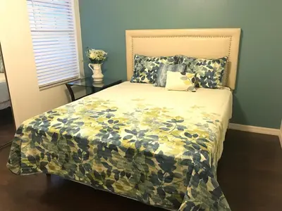 a bedroom with a bed with a camouflage bedspread at 10 minutes to all Disney parks with pool and wifi in Kissimmee