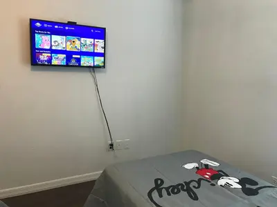 a room with a flat screen tv on a wall at 10 minutes to all Disney parks with pool and wifi in Kissimmee