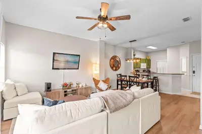 a living room with a couch and a ceiling fan at Peaceful Palms Stay for 6 in Kissimmee