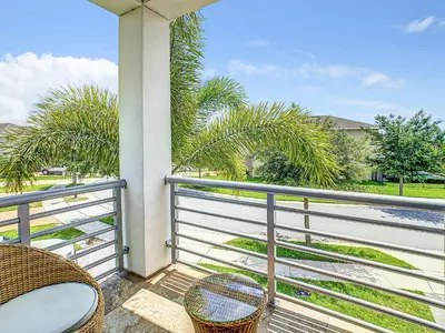 a balcony with two chairs and a view of the water at 160 Minton Loop in Orlando