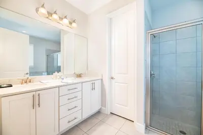 a bathroom with two sinks and a shower at 7484 Marker Avenue in Orlando