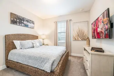 a bedroom with a bed and a dresser and a window at 7484 Marker Avenue in Orlando