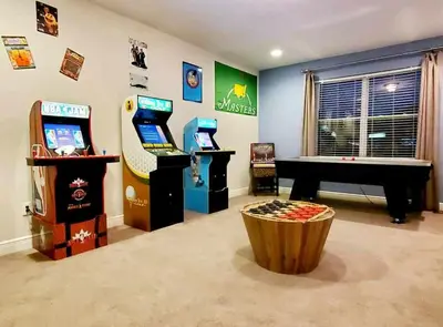 a room with two arcade games and a piano at 7484 Marker Avenue in Orlando