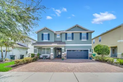 a large house with a driveway at 7503 Marker Avenue in Orlando