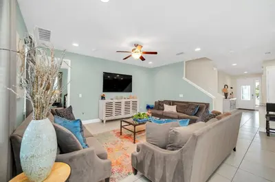 a living room with couches and a ceiling fan at 7503 Marker Avenue in Orlando